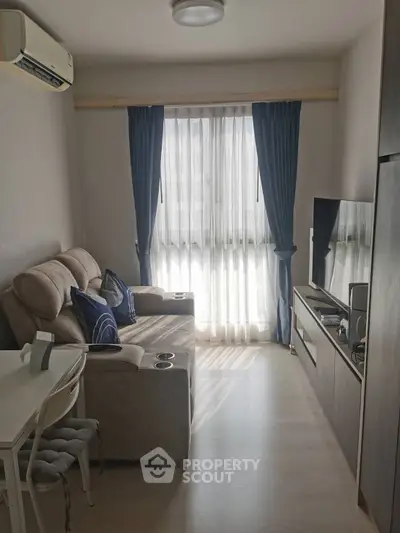 Cozy living room with natural light and modern furniture, perfect for relaxation.