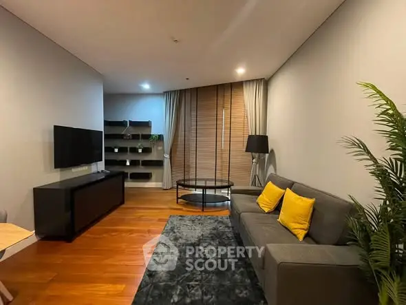 Modern living room with sleek furniture and wooden flooring