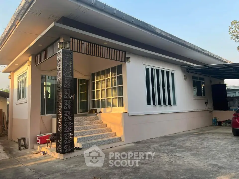 Charming single-story home with modern exterior design and spacious driveway, perfect for family living.