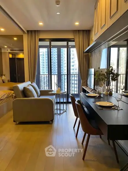 Modern open-plan living room with dining area and city view balcony