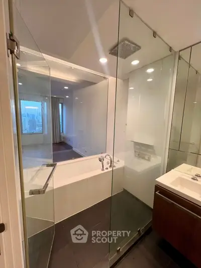 Luxurious modern bathroom with glass shower and city view window, sleek design and elegant fixtures.