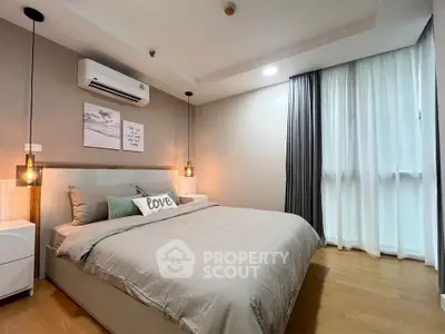 Modern bedroom with stylish decor and cozy ambiance in a contemporary apartment.