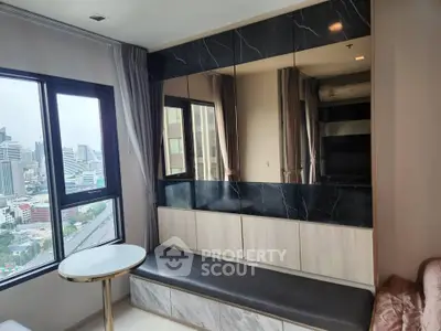 Modern living room with city view, marble accents, and stylish seating area.