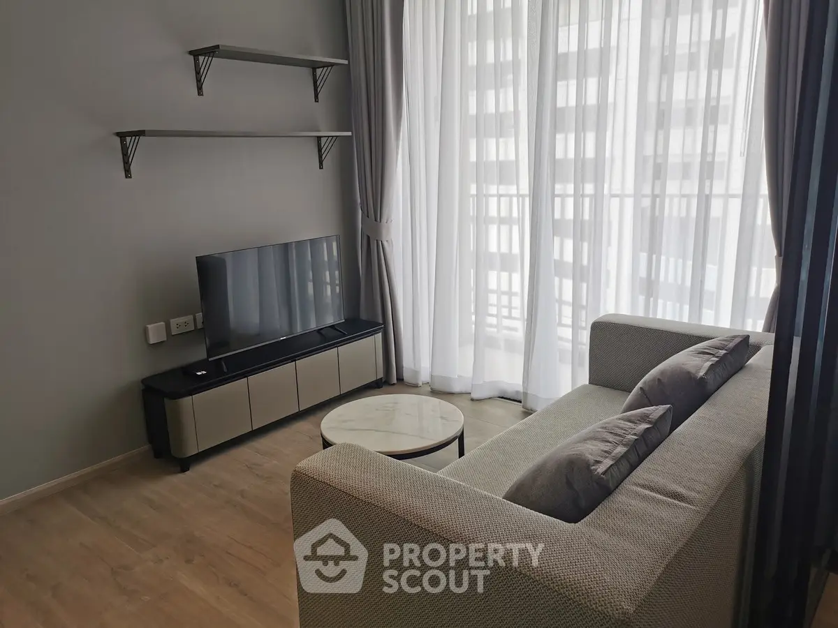 Modern living room with sleek furniture and large window for natural light