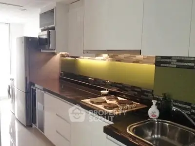 Modern kitchen with sleek appliances and stylish backsplash in a contemporary home.