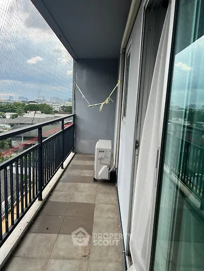Spacious balcony with city view in modern apartment building