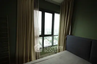 Cozy bedroom with large window offering a stunning city view, complemented by elegant curtains and a comfortable bed.