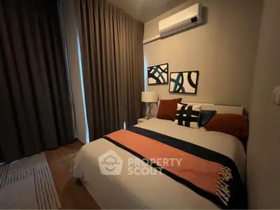 Cozy bedroom with modern decor and air conditioning in stylish apartment.