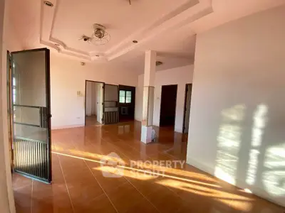 Spacious empty room with large windows and tiled floor, perfect for customization.