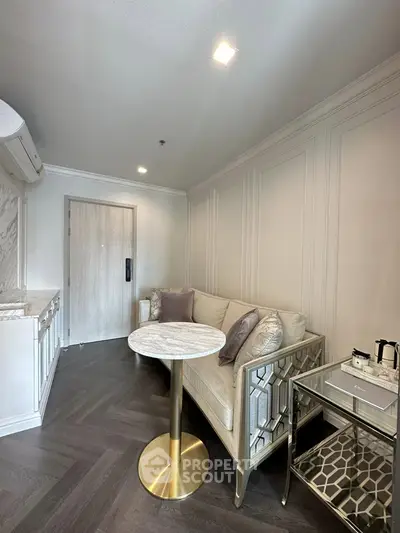 Elegant living room with modern sofa, chic table, and stylish decor in a cozy apartment.