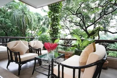 Luxurious balcony with elegant seating and lush garden views, perfect for relaxation and entertaining.