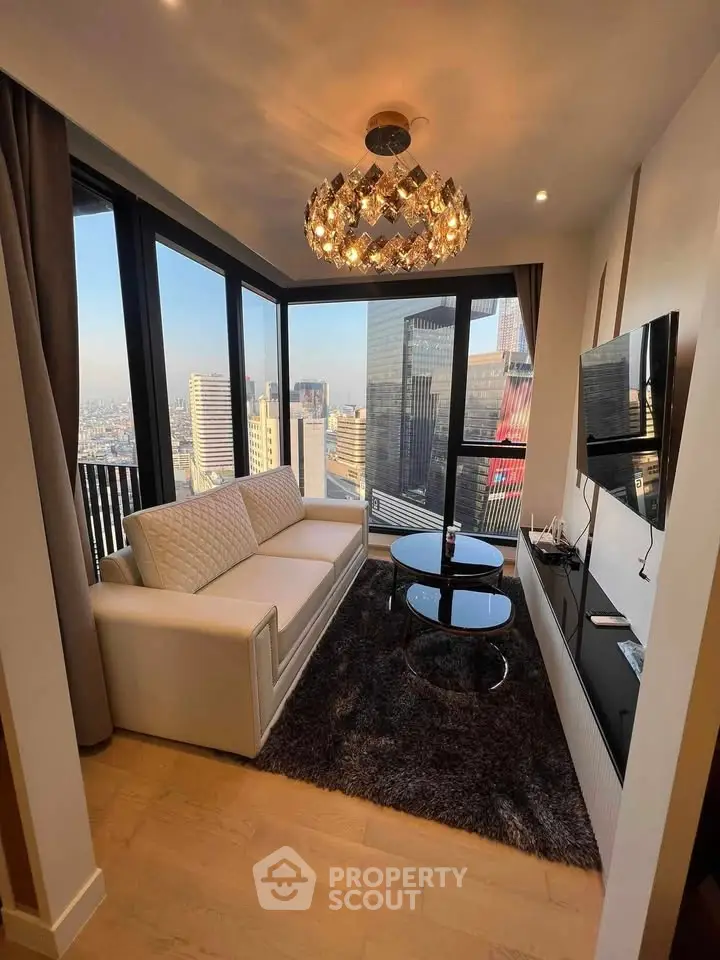 Luxurious modern living room with stunning city view, elegant chandelier, and sleek furnishings in high-rise apartment.
