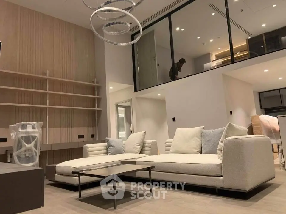 Luxurious modern living room with elegant sofa and stylish lighting in a spacious open-plan design.