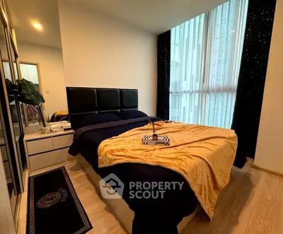 Modern bedroom with large window and stylish decor in urban apartment