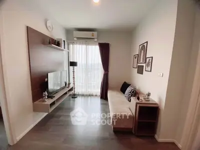 Modern living room with sleek decor and large window offering natural light.