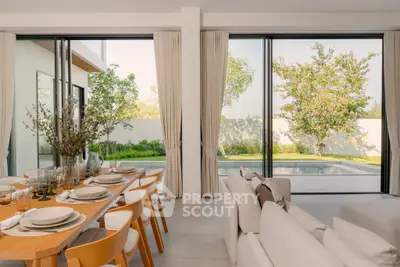 Luxurious open-plan living room with pool view and elegant dining setup