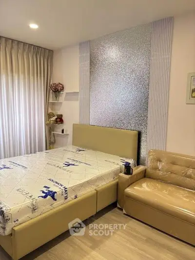 Modern bedroom with stylish decor and comfortable furnishings, featuring a cozy bed and elegant lighting.