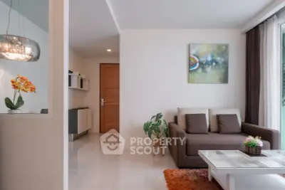 Modern living room with stylish decor and natural light, featuring a cozy sofa and vibrant artwork.