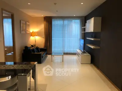 Modern living room with sleek furniture and large windows offering ample natural light.