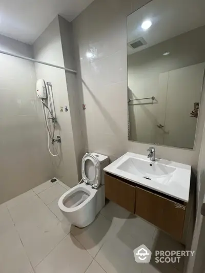 Modern bathroom with sleek fixtures and spacious design in a contemporary home.