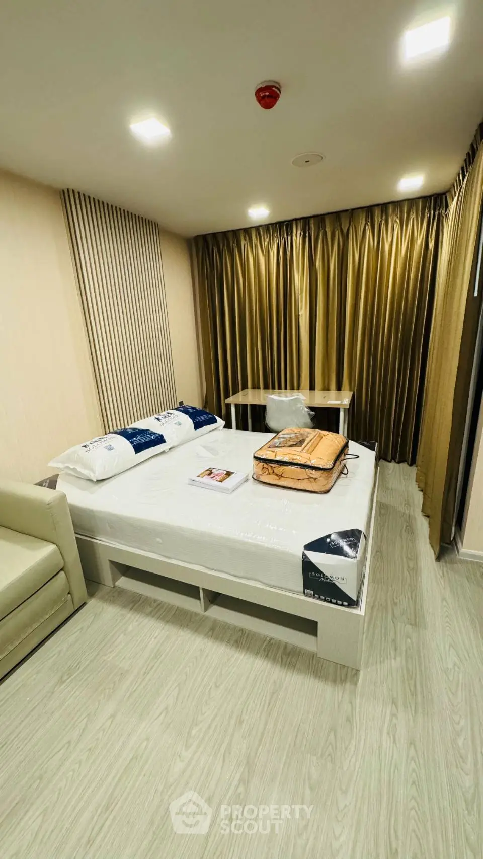 Modern bedroom with stylish decor and cozy ambiance, featuring a comfortable bed and elegant curtains.