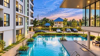 Luxurious apartment complex with stunning pool and modern architecture at sunset.