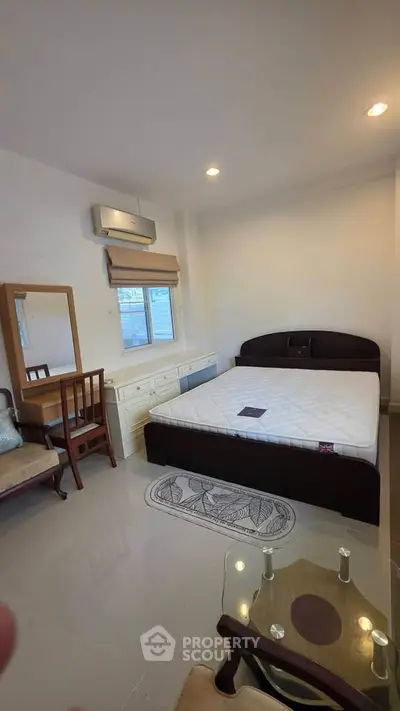 Spacious bedroom with modern furniture and natural light