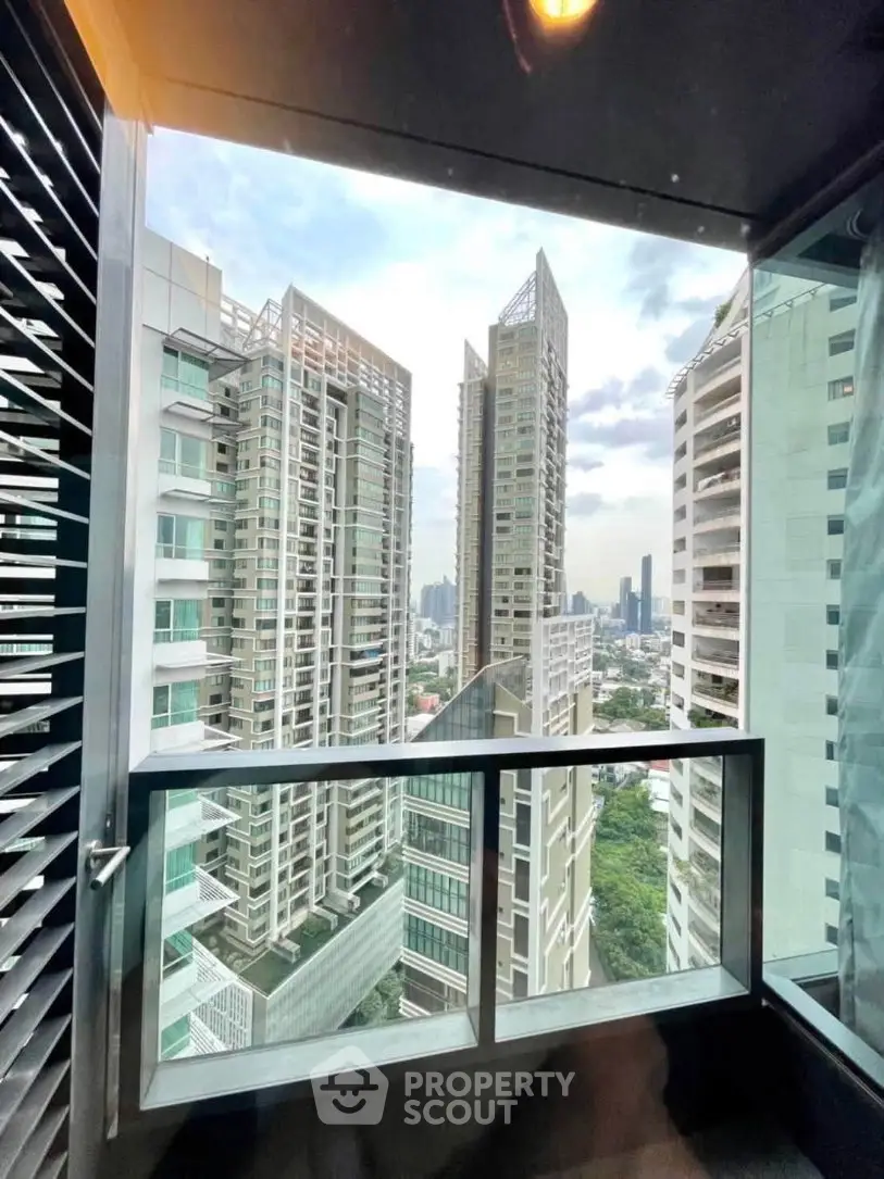 Stunning urban view from a modern high-rise balcony with city skyline.
