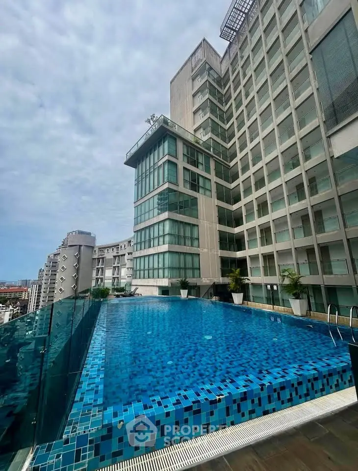 Luxurious rooftop infinity pool with stunning city views in modern high-rise building.