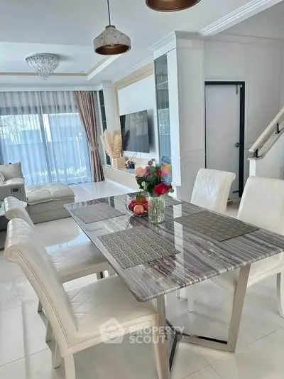 Elegant dining area with modern decor and natural light in a stylish home interior.