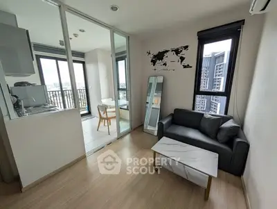Modern living room with sleek design and city view, featuring a cozy sofa and stylish decor.