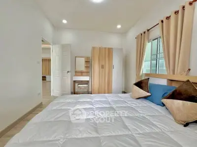 Cozy bedroom with modern decor and ample natural light