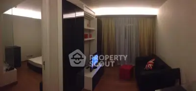 Modern living room with sleek design, featuring a cozy sofa, TV unit, and ambient lighting for a stylish ambiance.