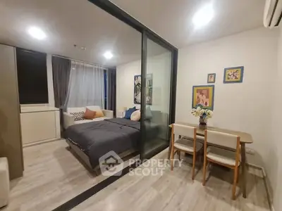 Modern studio apartment with glass partition and cozy dining area