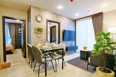 Modern living room with dining area, stylish decor, and natural light in a contemporary apartment.