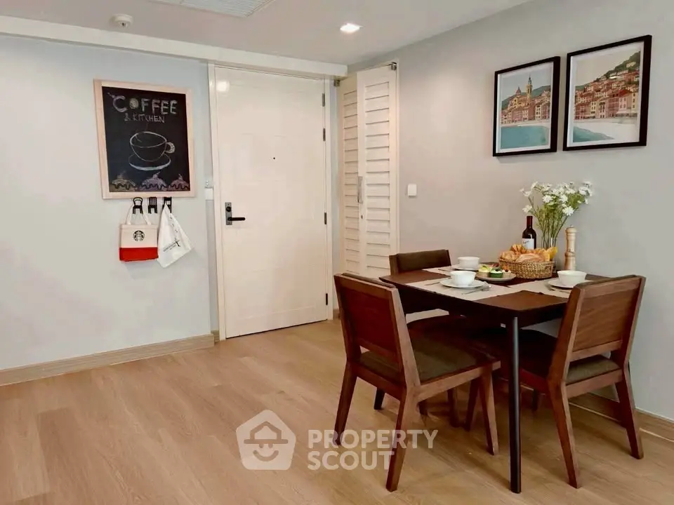 Charming dining area with wooden table and chairs, perfect for cozy meals.