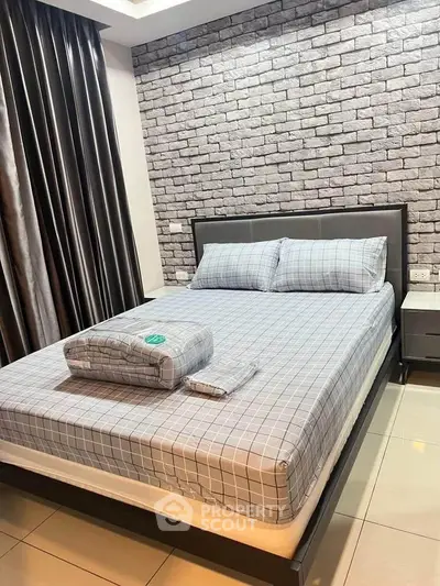 Modern bedroom with stylish brick accent wall and sleek furnishings