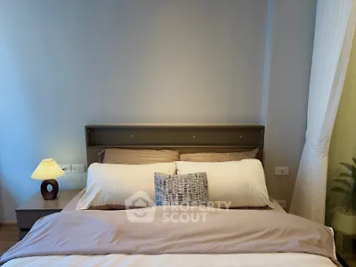 Cozy bedroom with modern decor and soft lighting, perfect for relaxation.