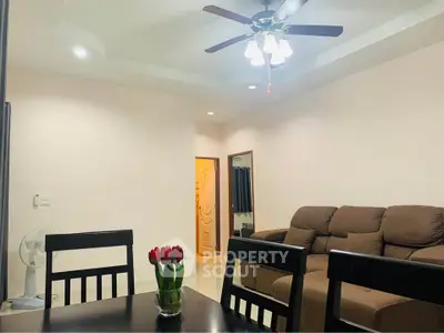 Cozy living room with ceiling fan and comfortable seating