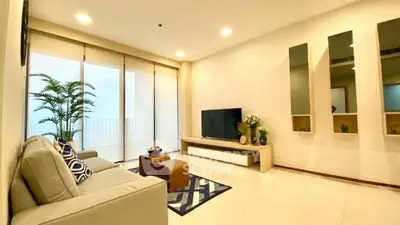 Spacious modern living room with large windows and stylish decor