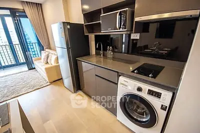 Modern kitchen with sleek appliances and balcony view in a stylish apartment.