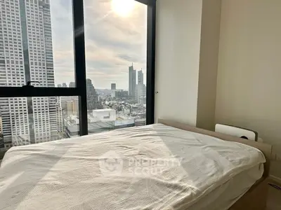 Modern bedroom with stunning city view from high-rise apartment window.