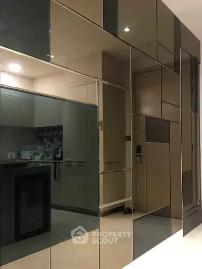 Modern kitchen with sleek mirrored cabinets and contemporary design