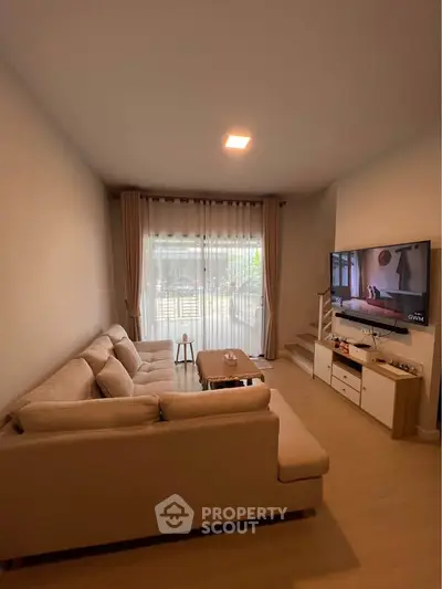 Cozy living room with modern decor and large window view