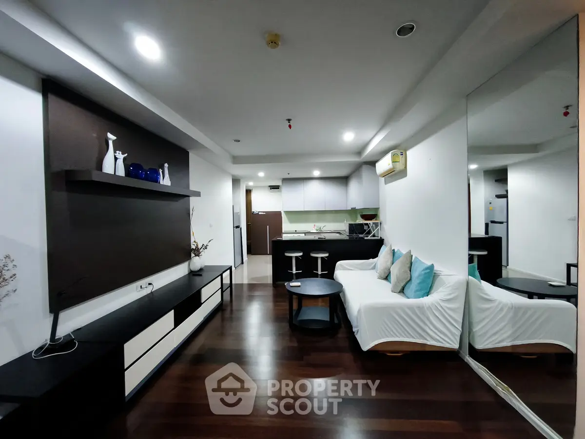 Modern living room with sleek design and open kitchen layout