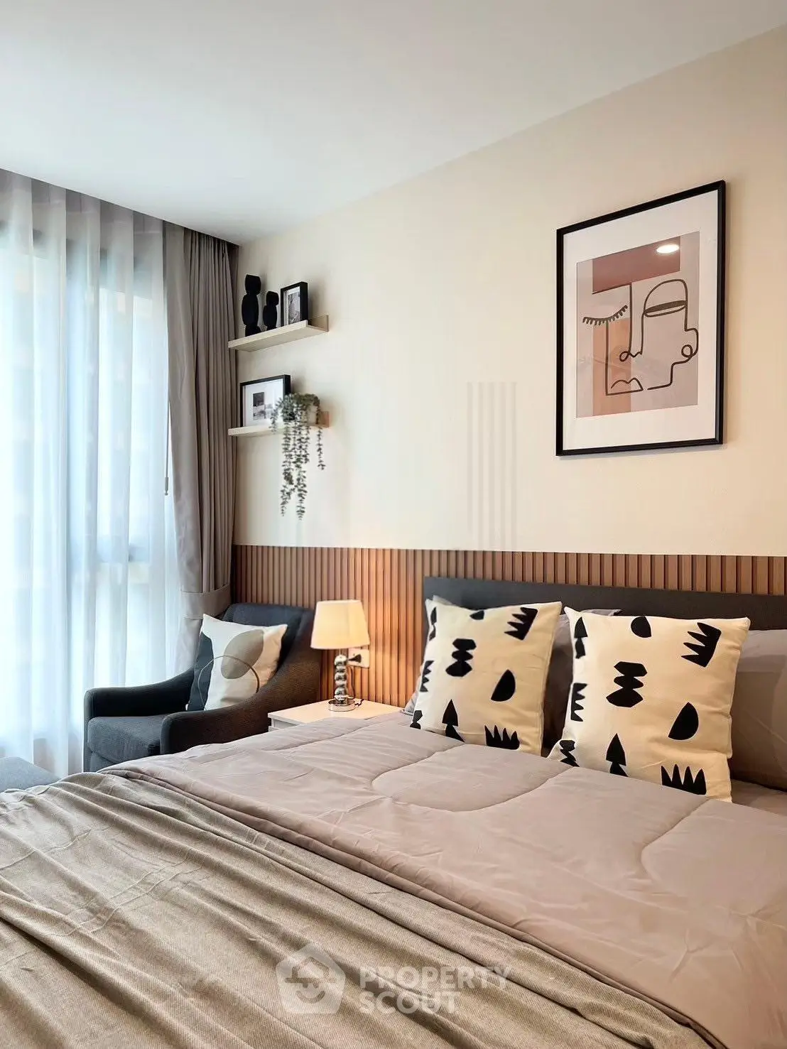 Modern bedroom with stylish decor and natural light, featuring cozy bedding and elegant wall art.