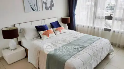 Elegant bedroom with city view, featuring stylish decor and natural light.