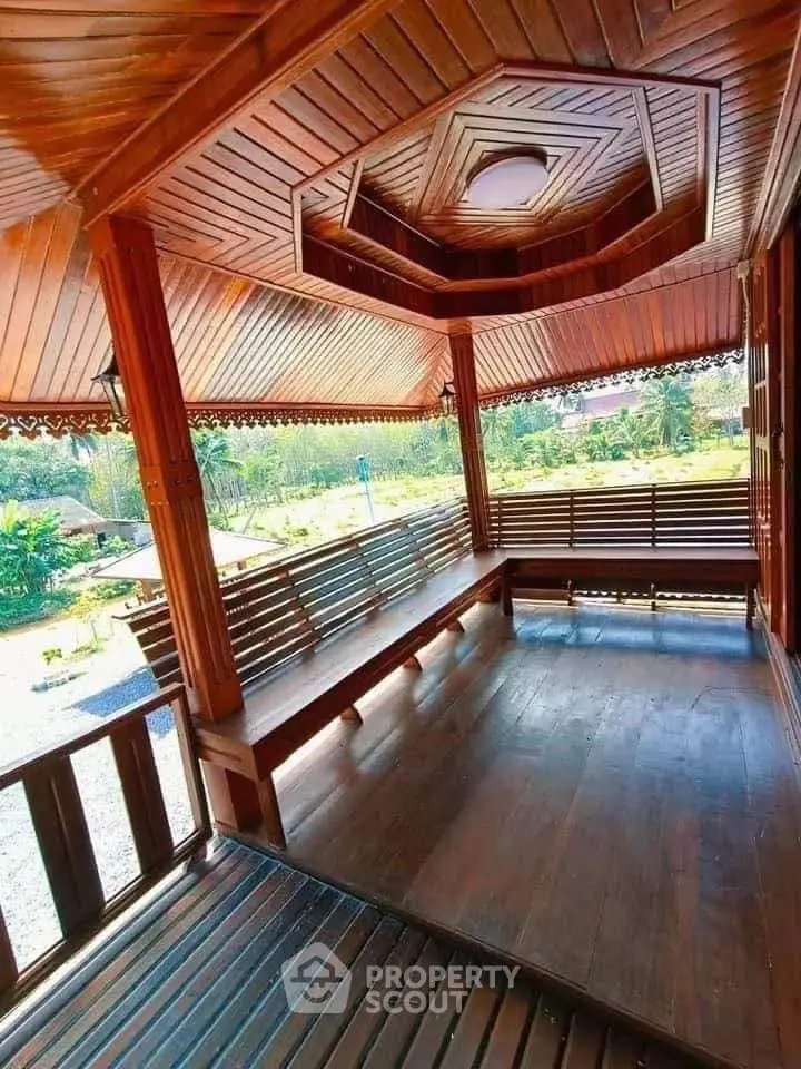 Stunning wooden gazebo with intricate ceiling design and scenic garden view, perfect for relaxation.