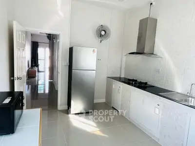 Modern kitchen with sleek appliances and open layout in bright apartment