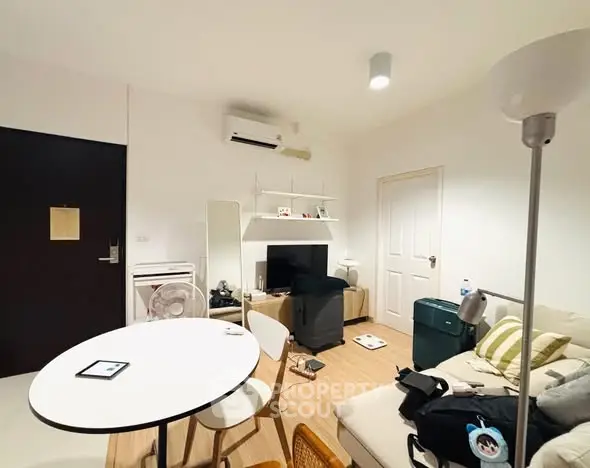 Cozy living room with modern decor and air conditioning, perfect for relaxation.